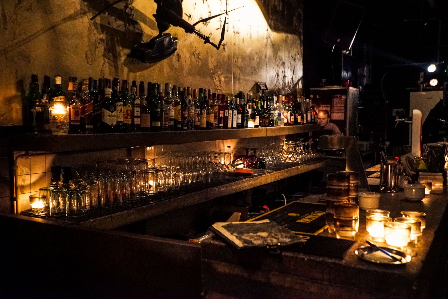 An empty bar counter lit warmly at night